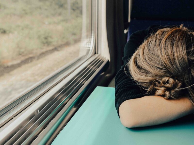 sleeping woman in train at daytime