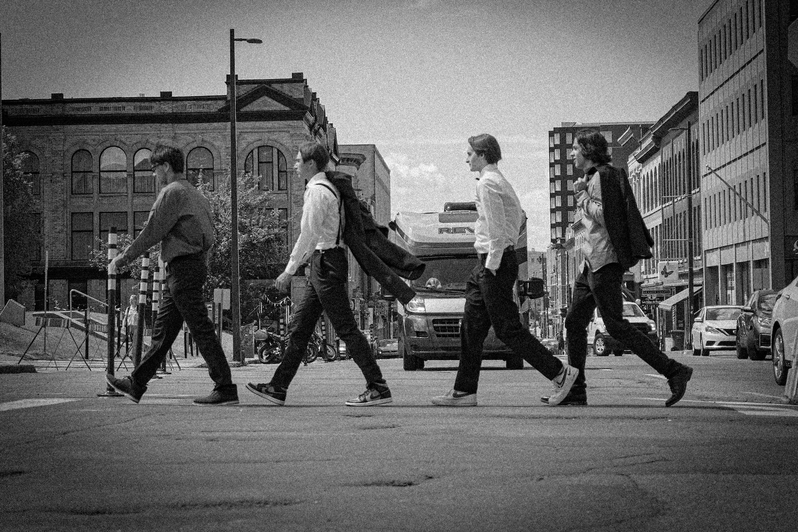 a group of men walking across a street