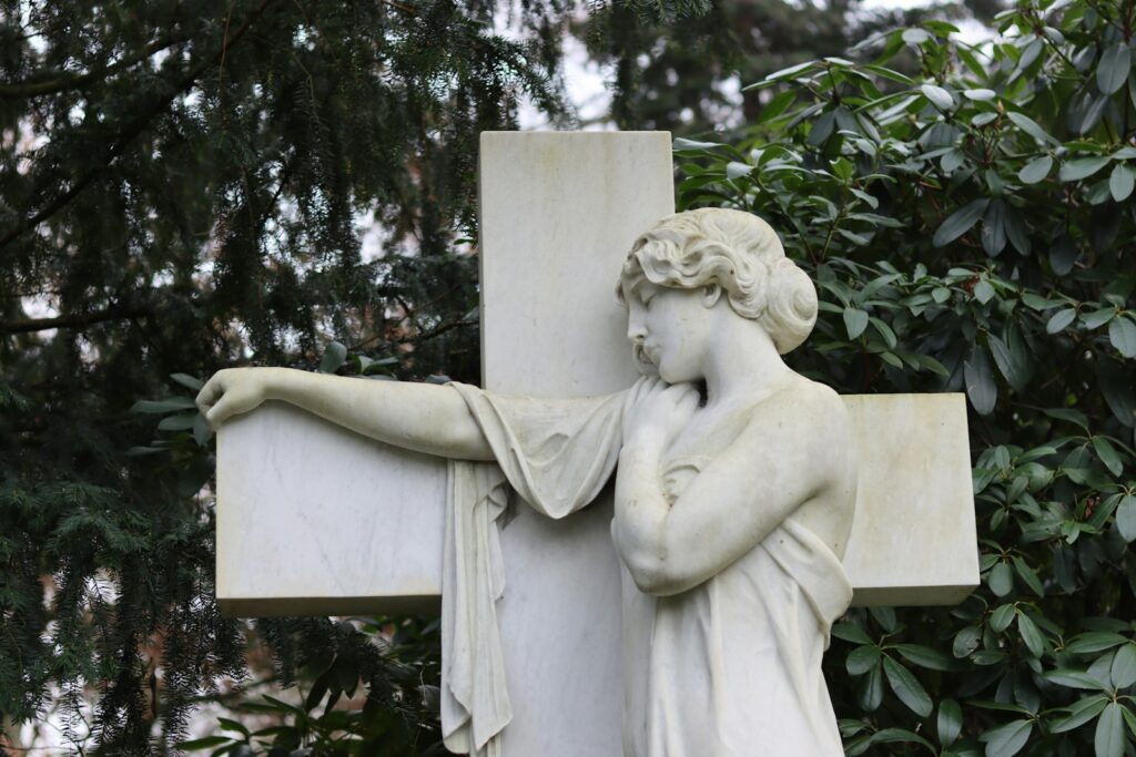 a statue of a woman holding a cross