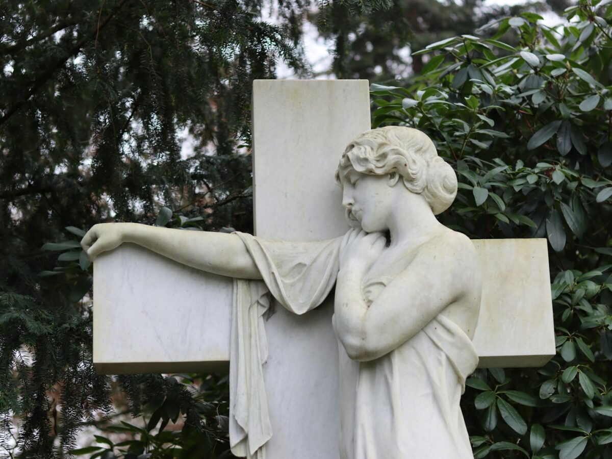 a statue of a woman holding a cross